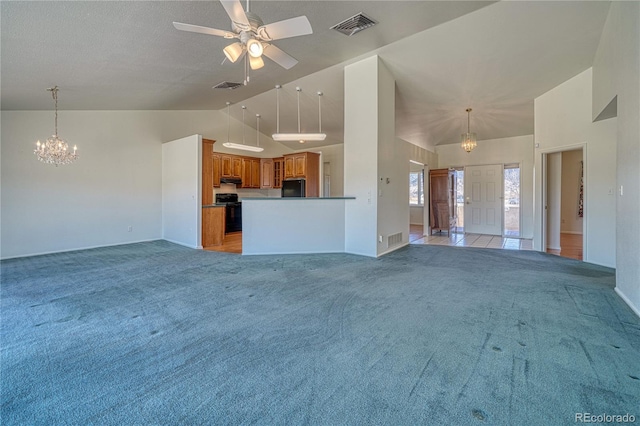 unfurnished living room featuring light carpet, ceiling fan with notable chandelier, and high vaulted ceiling