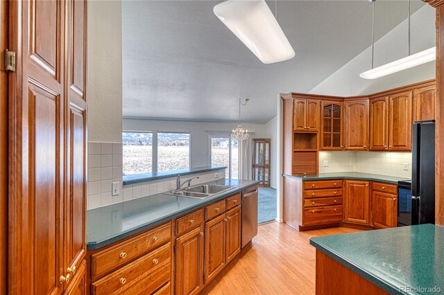 kitchen featuring black refrigerator, electric range oven, dishwasher, sink, and light wood-type flooring