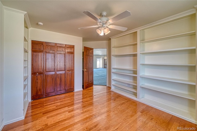 unfurnished bedroom with a closet, ceiling fan, and light wood-type flooring