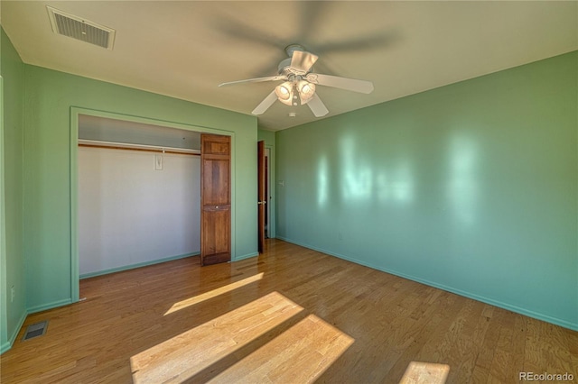 unfurnished bedroom featuring wood-type flooring, a closet, and ceiling fan