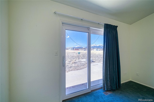 doorway to outside featuring dark colored carpet