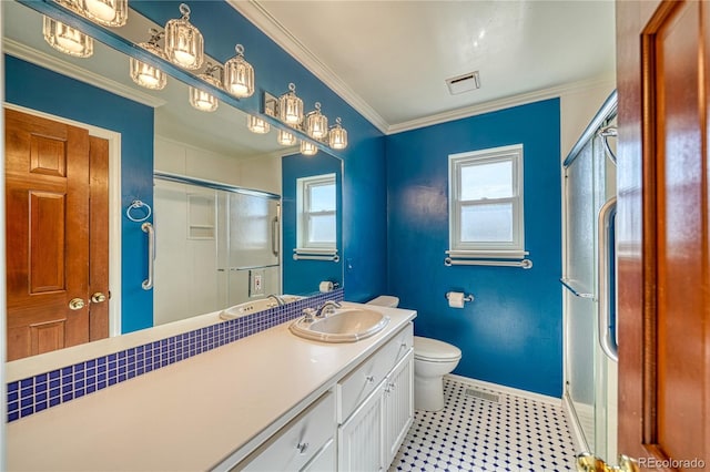 bathroom with crown molding, vanity, toilet, and a shower with shower door