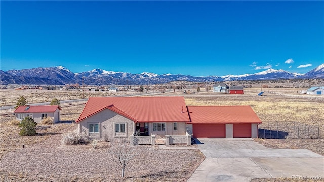 single story home with a garage and a mountain view