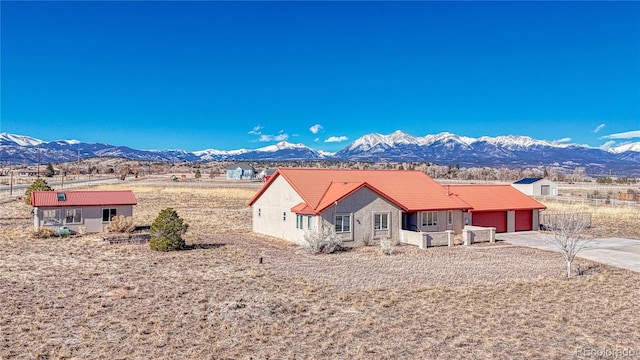 exterior space with a garage and a mountain view