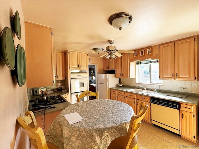 kitchen featuring ceiling fan, sink, white appliances, and decorative backsplash