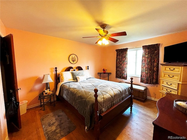 bedroom with ceiling fan and wood-type flooring