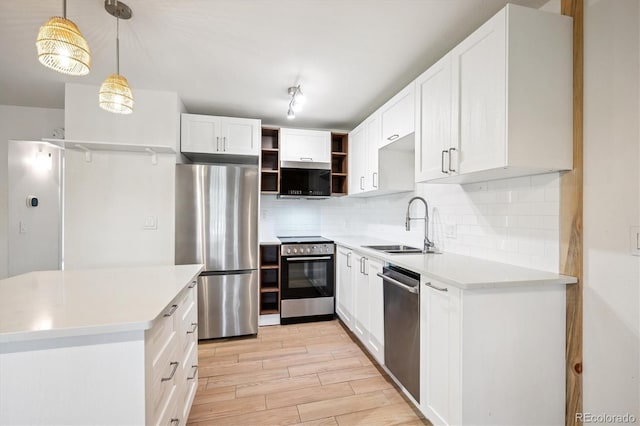 29656 Buffalo Park Rd Unit 208, Evergreen, CO 80439 - kitchen with appliances with stainless steel finishes, open shelves, light wood-style floors, decorative backsplash, and white cabinetry