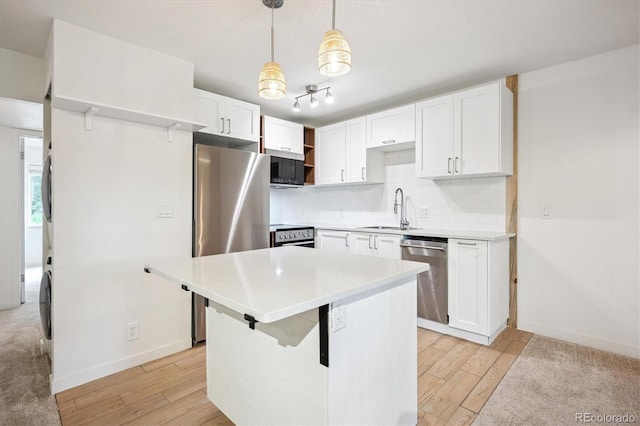 29656 Buffalo Park Rd Unit 208, Evergreen, CO 80439 - kitchen with appliances with stainless steel finishes, white cabinetry, and light wood-style floors