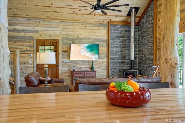 2474 Wendt Ln, Fort Garland, CO 81133 - dining area featuring a ceiling fan, wood ceiling, a wood stove, lofted ceiling, and wood walls