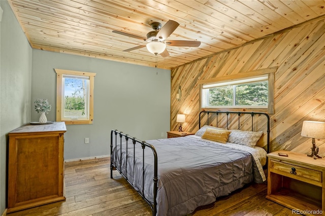 2474 Wendt Ln, Fort Garland, CO 81133 - bedroom featuring wood ceiling, wooden walls, hardwood / wood-style flooring, and a ceiling fan