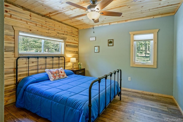 2474 Wendt Ln, Fort Garland, CO 81133 - bedroom featuring wooden ceiling, multiple windows, hardwood / wood-style floors, wood walls, and a ceiling fan