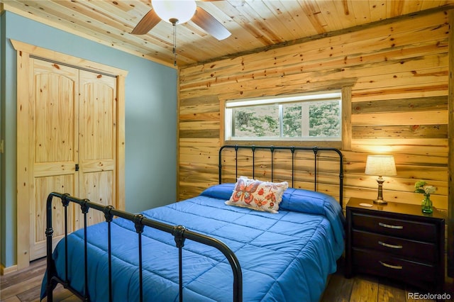 2474 Wendt Ln, Fort Garland, CO 81133 - bedroom featuring wooden walls, wood finished floors, wooden ceiling, ceiling fan, and a closet