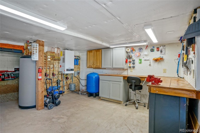 2474 Wendt Ln, Fort Garland, CO 81133 - below grade area featuring a workshop area, gas water heater, and a water pressure tank