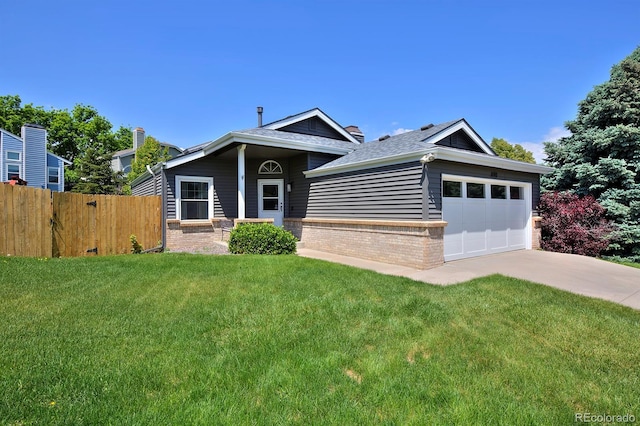 690 W Jamison Cir, Littleton, CO 80120 - view of front of property with brick siding, an attached garage, driveway, and roof with shingles