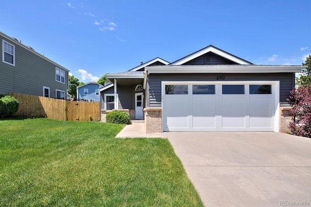 690 W Jamison Cir, Littleton, CO 80120 - view of front of home featuring driveway, an attached garage, and stone siding