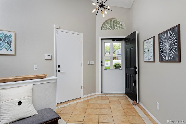 690 W Jamison Cir, Littleton, CO 80120 - foyer entrance featuring a chandelier, baseboards, a high ceiling, and light tile patterned floors