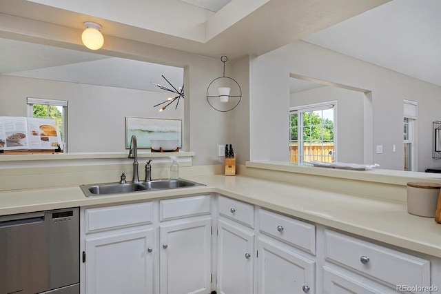 690 W Jamison Cir, Littleton, CO 80120 - kitchen with stainless steel dishwasher, a sink, white cabinets, and light countertops