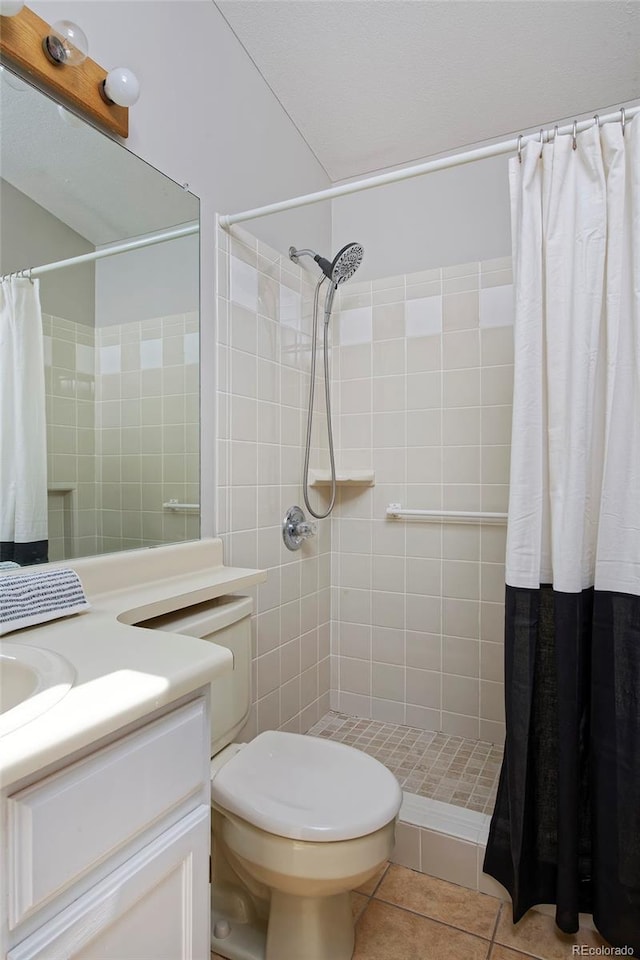 690 W Jamison Cir, Littleton, CO 80120 - full bathroom featuring vanity, tiled shower, tile patterned flooring, and toilet