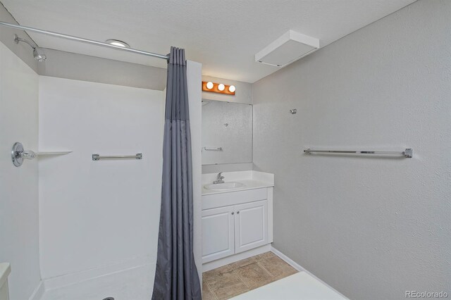 690 W Jamison Cir, Littleton, CO 80120 - bathroom featuring vanity, a shower with shower curtain, and baseboards