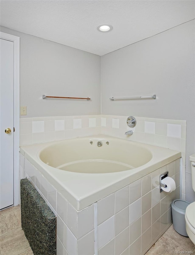 690 W Jamison Cir, Littleton, CO 80120 - bathroom featuring toilet, a bath, and tile patterned floors