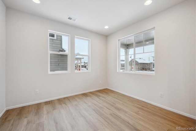 empty room with light hardwood / wood-style floors