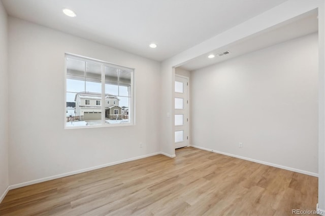 spare room with light hardwood / wood-style flooring