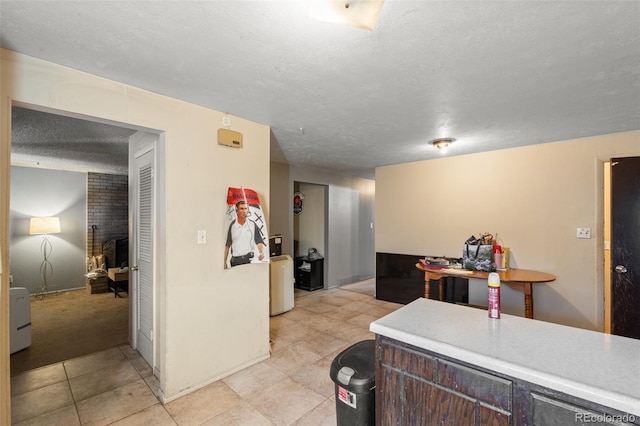 kitchen with washer / dryer and a textured ceiling