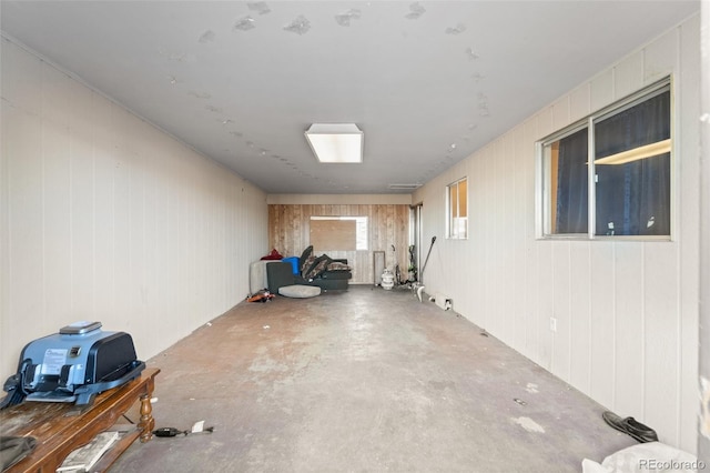 basement featuring wooden walls