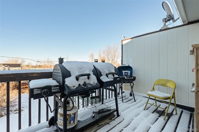 snow covered deck with area for grilling