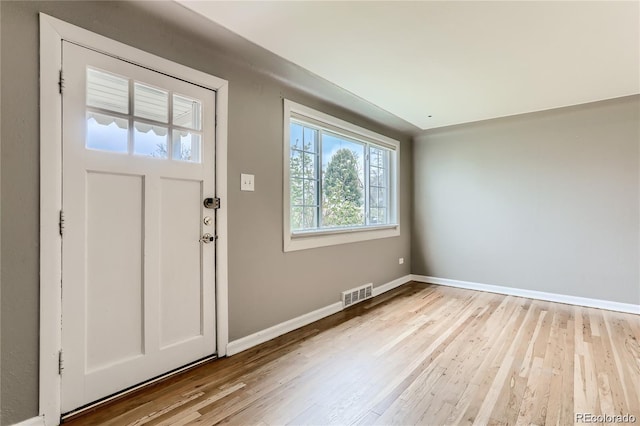 entrance foyer featuring visible vents, light wood-type flooring, and baseboards