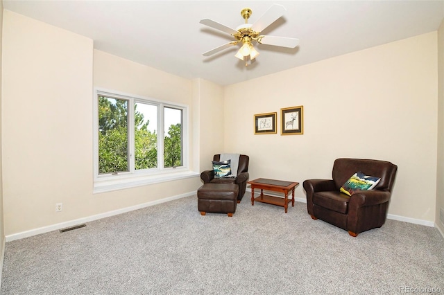 sitting room with baseboards, visible vents, carpet floors, and ceiling fan