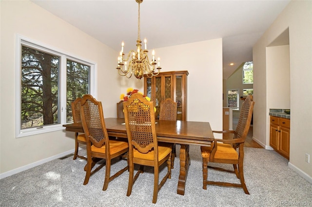 dining space with vaulted ceiling, baseboards, a wealth of natural light, and a chandelier