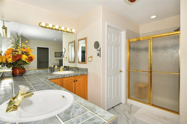 bathroom with vanity, marble finish floor, and a shower stall