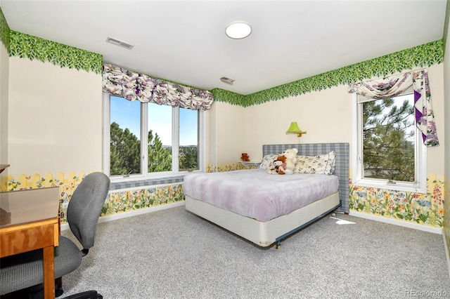 carpeted bedroom with visible vents, wallpapered walls, and baseboards