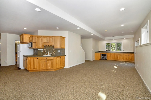 kitchen featuring dark countertops, tasteful backsplash, baseboards, carpet floors, and recessed lighting