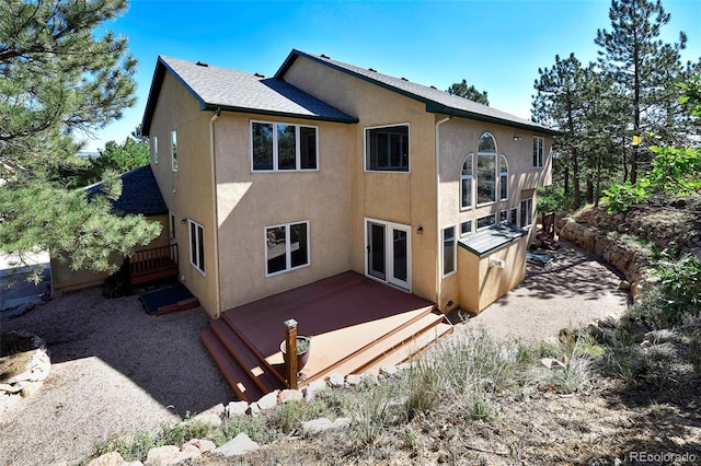 back of property featuring stucco siding and a deck