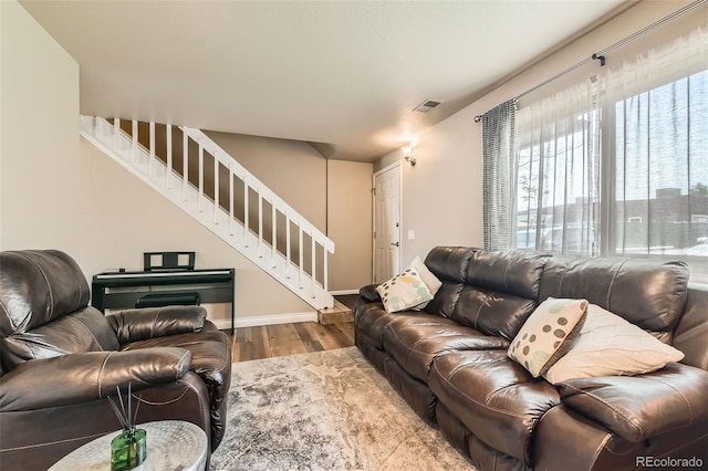 15139 E Wesley Ave, Aurora, CO 80014 - living area featuring stairs, wood finished floors, and baseboards