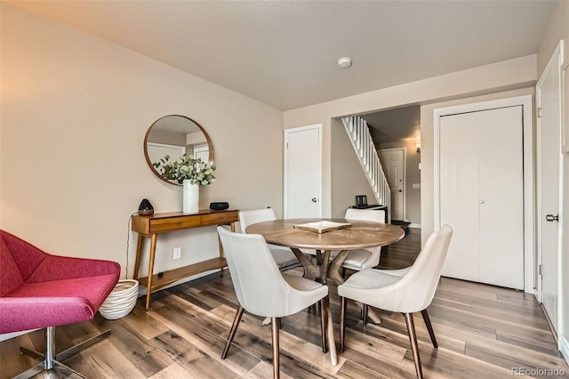 15139 E Wesley Ave, Aurora, CO 80014 - dining area featuring stairway, light wood-type flooring, and baseboards