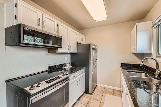 15139 E Wesley Ave, Aurora, CO 80014 - kitchen featuring stainless steel appliances, a sink, white cabinetry, dark stone countertops, and light tile patterned floors
