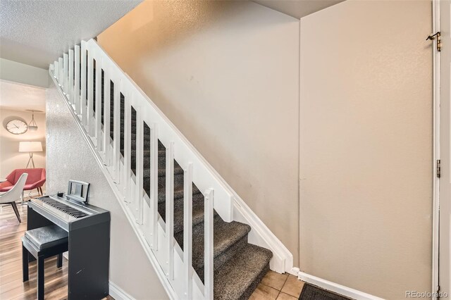 15139 E Wesley Ave, Aurora, CO 80014 - stairs with baseboards and tile patterned flooring