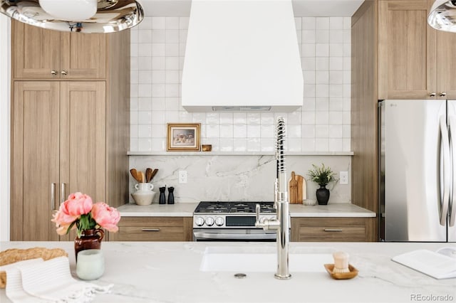 3932 Kalamath St, Denver, CO 80211 - kitchen featuring appliances with stainless steel finishes, custom exhaust hood, backsplash, and light stone counters