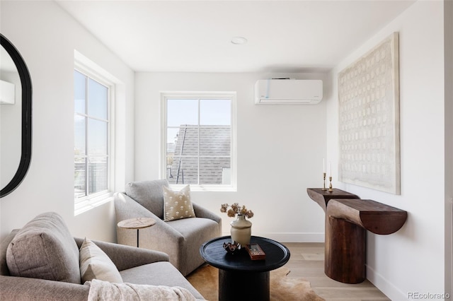3932 Kalamath St, Denver, CO 80211 - living area featuring a wall mounted AC, wood finished floors, and baseboards