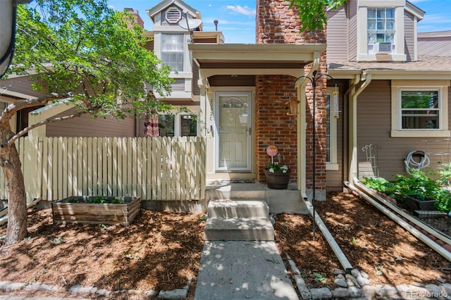 2092 S Helena St Unit C, Aurora, CO 80013 - property entrance with brick siding, a chimney, and cooling unit