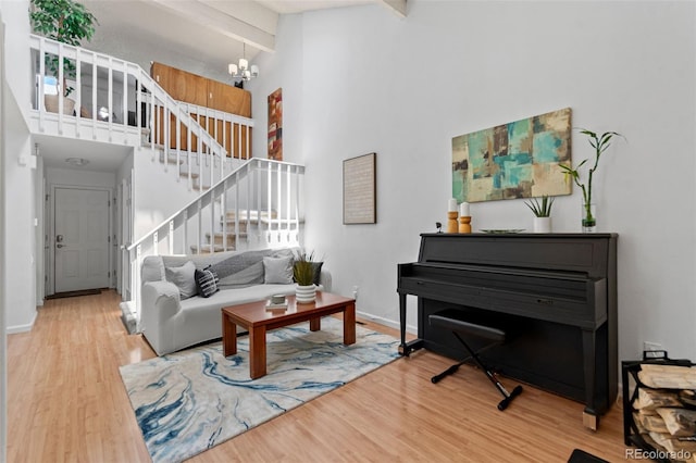 2092 S Helena St Unit C, Aurora, CO 80013 - living room featuring a high ceiling, stairs, a chandelier, wood finished floors, and beam ceiling