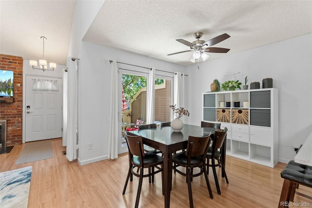 2092 S Helena St Unit C, Aurora, CO 80013 - dining area featuring a textured ceiling, light wood-style flooring, a chandelier, and ceiling fan