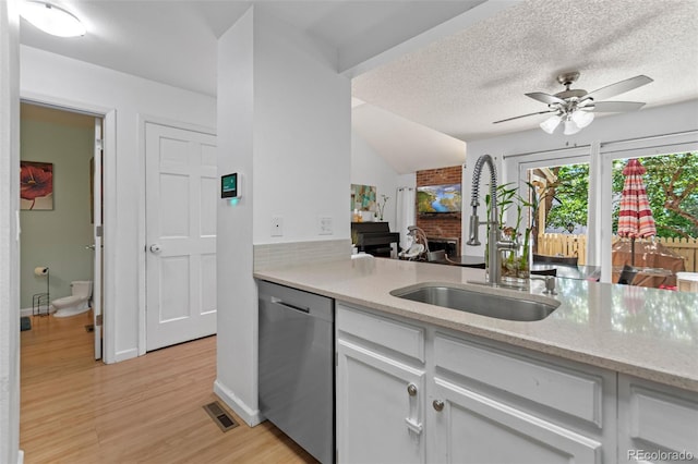2092 S Helena St Unit C, Aurora, CO 80013 - kitchen with dishwasher, a ceiling fan, white cabinets, light stone counters, and light wood finished floors