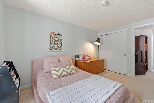 2092 S Helena St Unit C, Aurora, CO 80013 - bedroom featuring light colored carpet, a closet, and a textured ceiling