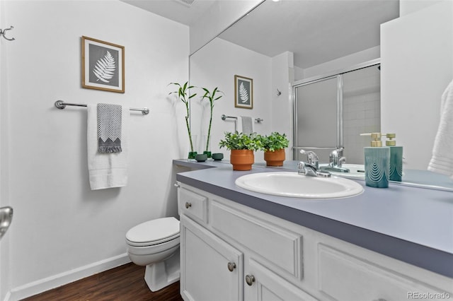 2092 S Helena St Unit C, Aurora, CO 80013 - bathroom featuring vanity, a shower with shower door, and wood finished floors