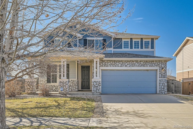 view of front of home with driveway, stone siding, fence, covered porch, and a garage