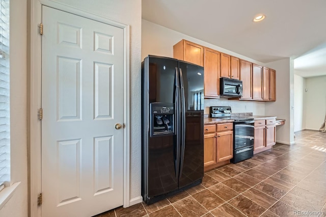 kitchen featuring black appliances, recessed lighting, and baseboards